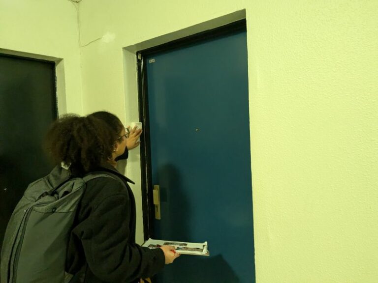 l'image montre une personne toquant à une porte dans un couloir d'immeuble